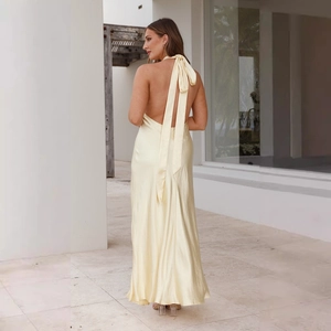 Detail of elegant satin halter neck dress with long bow tie at the open back