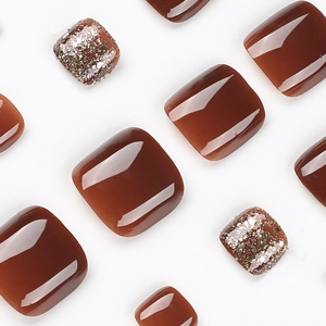 Glossy coffee brown press-on toenails with glitter and shimmer finish on white background