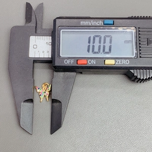 Macro view of crystal zircon butterfly pendant measuring 10.0mm with digital caliper