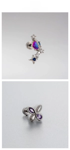 Macro shot of silver butterfly stud and star planet earrings with purple and blue zircon
