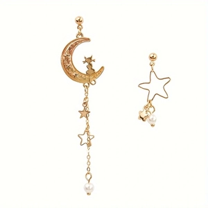 Asymmetric gold cat moon and star dangle earrings with pearls on white background