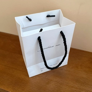 White paper jewelry gift bag with black rope handles and Sunshine acc smiley print