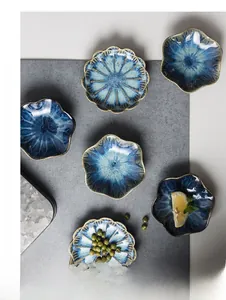 Detailed top view of retro petal-shaped ceramic plates with deep blue reactive glaze texture