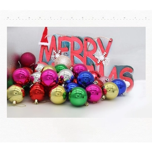 Close-up of assorted glossy and glitter Christmas balls with Merry Christmas signage