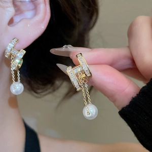 Detail of 14K gold plated H-letter pearl drop earrings with sparkling cubic zirconia inlay