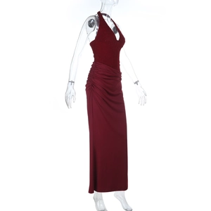 Detail of burgundy halter neck dress with sequined lace bodice and side draping texture