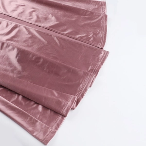 Detailed close-up of pink velvet fabric showing premium stitching and soft texture