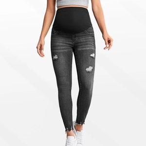 Close-up of high-elasticity black belly band and distressed ripped denim texture