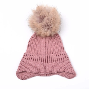 Winter rose pink knit earflap hat with soft faux fur pompom for cold weather warmth