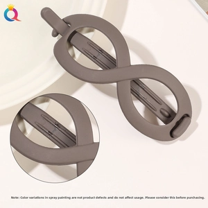 Detail view of large matte coffee infinity-shaped resin hair claw with smooth frosted finish