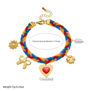 Colorful woven rope bracelet with gold-plated sun and heart pendants plus pearl detail