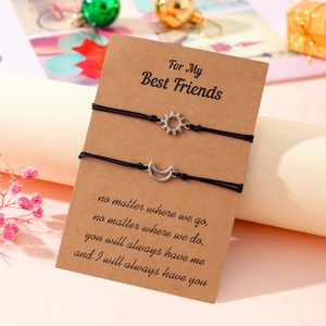 Detail of woven sun and moon bracelets set for friends on vintage gift card packaging