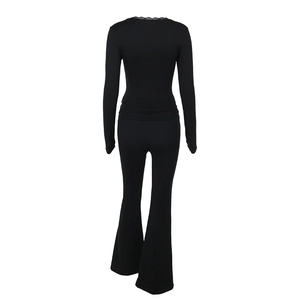 Rear view of black long-sleeve jumpsuit with lace V-neck and flared pants design