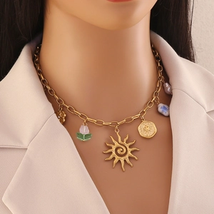 Golden stainless steel necklace featuring sun pendant and tulip charms on female model
