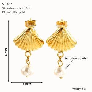 Detail view of 18k gold plated shell earrings with pearls and size measurements