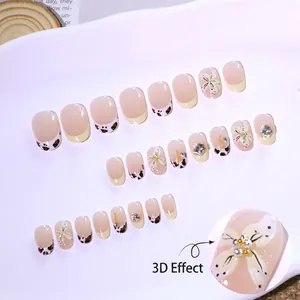 Short round press-on nails with 3D flower, pearls, and leopard print French tips
