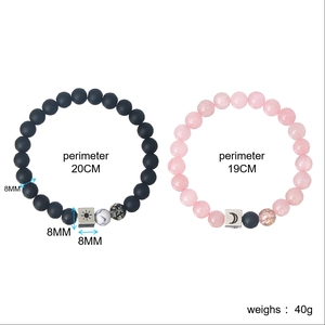 Detail showing sun and moon charms on matte obsidian and rose quartz beaded bracelets