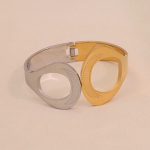 Two-tone gold and silver stainless steel cutout bangle with geometric hollow design