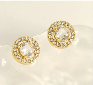 Macro detail of gold-plated double-layer earrings with sparkling cubic zirconia crystals