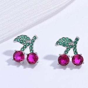 Detail of silver cherry stud earrings with red and green sparkling rhinestones