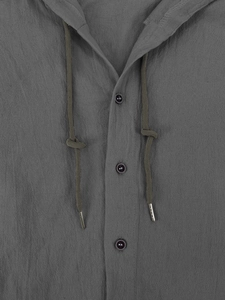 Detail of dark gray cotton linen shirt showing dark buttons and metal-tipped drawstring