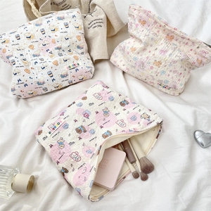 Detail view of large capacity quilted makeup bag with cute cartoon animal prints