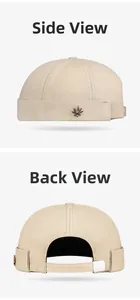 Detail view of beige canvas miki hat showing metal leaf logo and adjustable back strap