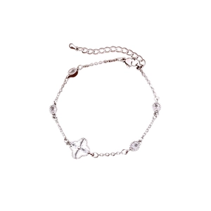 Silver flower bracelet with oval cubic zirconia and clover charm on white background