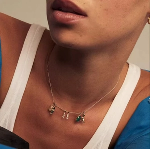 Gold s925 silver necklace with sparkling number 25 pendant on elegant model neck