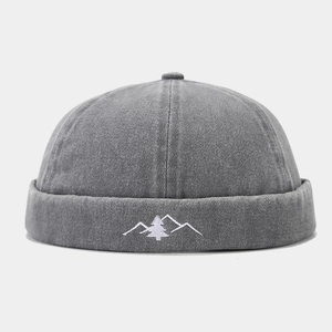 Detail of vintage washed docker hat featuring white mountain and tree embroidery art