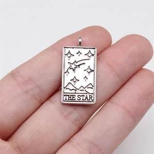 Antique silver rectangular tarot card pendant featuring The Star design held in hand
