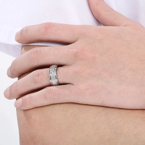 Close-up of titanium steel ring with gear texture and centered cubic zirconia stone