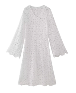 Detailed view of intricate white lace embroidery and V-neckline on long sleeve dress