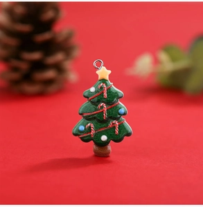 Close-up of resin Christmas tree charm with candy cane and star on a festive red background