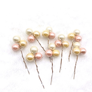 Pink, champagne, and cream artificial pearl picks on white faux fur for DIY decor