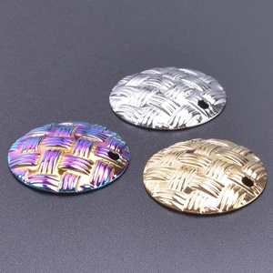 Macro shot of circular woven textured charms in silver gold and rainbow plating