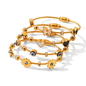 Set of 4 gold stainless steel cable bracelets with butterfly and evil eye charms
