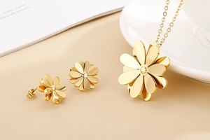 Macro shot of gold daisy jewelry set including petal pendant necklace and stud earrings
