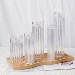 Set of 5 transparent cylindrical plastic candle molds with vertical stripe texture design