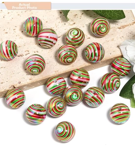Close-up of red, green, and white spiral striped acrylic Christmas beads for DIY crafts