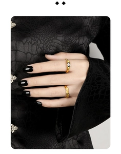 Detail of minimalist gold-plated 925 silver rings with zircon on a model's hand