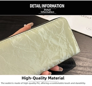 Close-up of light green PU leather wallet with pleated texture and black zipper detail