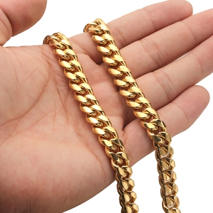 Close-up of golden stainless steel Cuban link necklace with a crystal-studded buckle