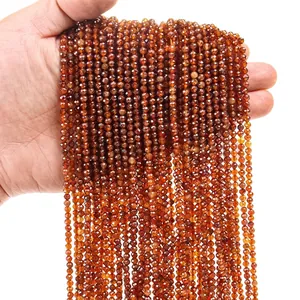 Macro shot of 3mm brown faceted natural stone round beads held in hand for jewelry making