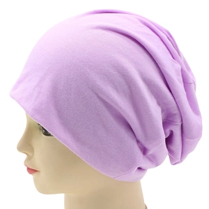 Detailed side view of a light purple knitted slouchy beanie on a mannequin head