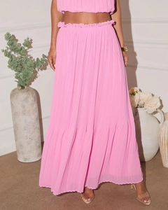 Close-up of pink two-piece set showing detailed pleated texture and high-waisted skirt