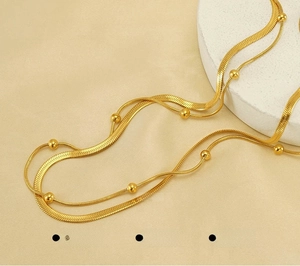 Close-up of golden double-layer herringbone chain made of polished stainless steel