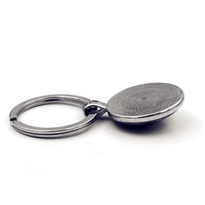 Silver metal sewing machine keychain with a blank round bezel for DIY photo craft