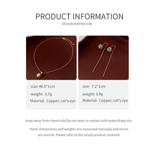 Detail view of 18K gold plated cat's eye pendant necklace and matching long earrings set