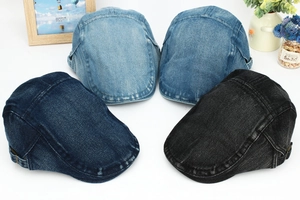 Detail of adjustable metal buckle and washed denim fabric on various ivy flat caps